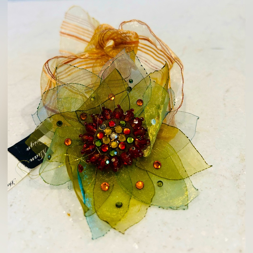 New with tags pretty ribbon bracelet. Beaded rhinestone flower centre design.